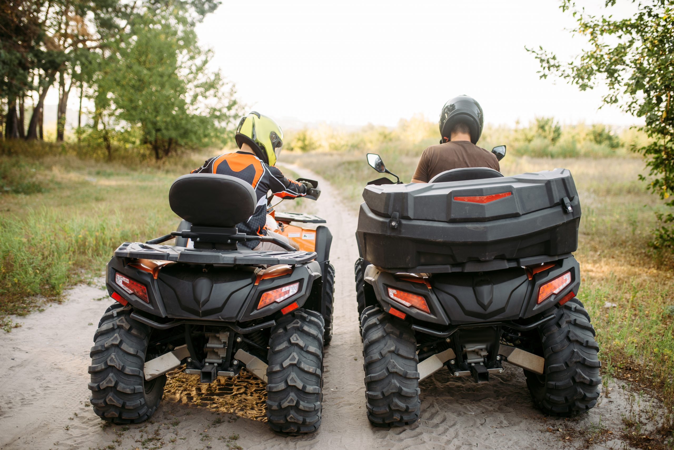 two-atv-riders-in-helmets-back-view-quad-bike-ZHTDRAK-scaled